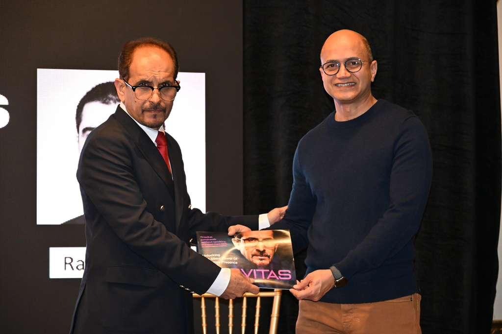 Amir Khan presenting GRAVITAS book to Raghib Hussain, CEO of Altera