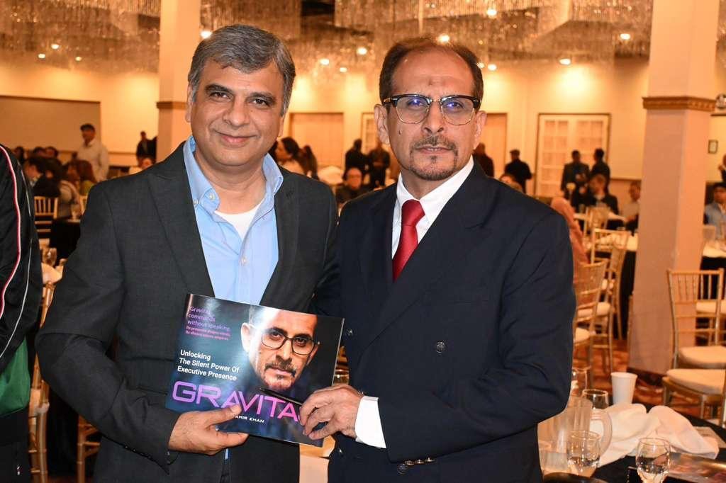 Amir Khan presenting GRAVITAS book to Mukhtiar Shaikh, Senior Distinguished Engineer at Palo Alto Networks